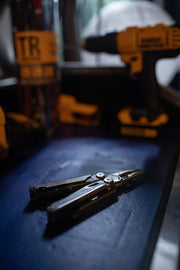 Leatherman Wave+ multi-tool on a work surface, folded and ready
