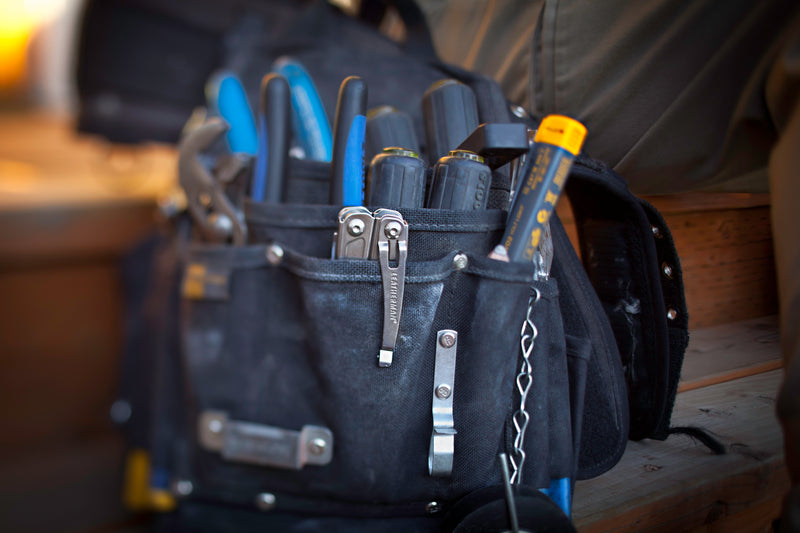 14-in-1 multi-tool stored in black canvas tool pouch with belt clip