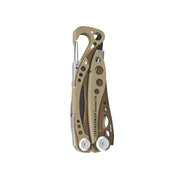 Tan Skeletool CX multi-tool with pliers and carabiner-style clip, folded open